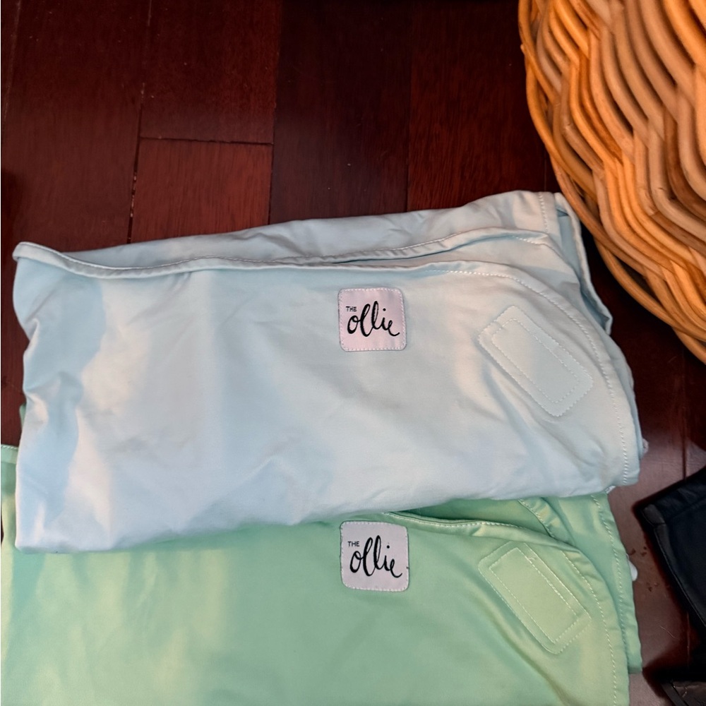 One blue and one green ollie swaddle